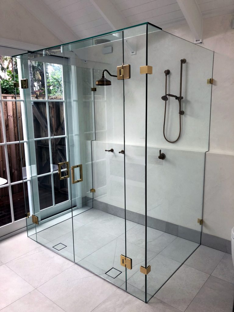 Frameless glass double shower screen with brass hardware